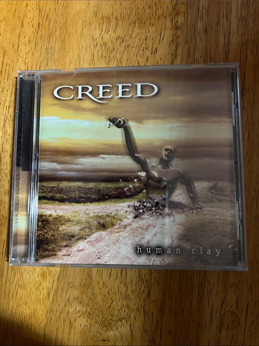 Creed Human Clay CD Cover Art — Brown, Gold & Tan Tones